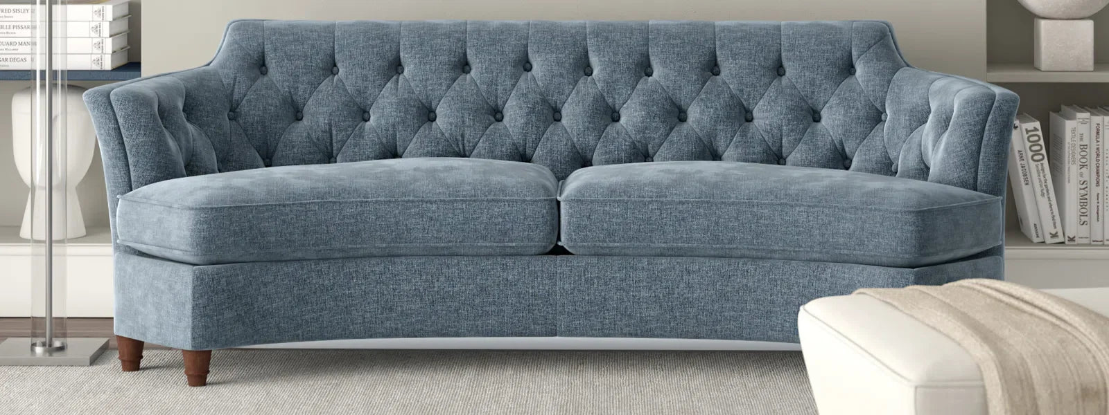 Ambella Home bench-made upholstery and carved casegoods in a warm residential setting